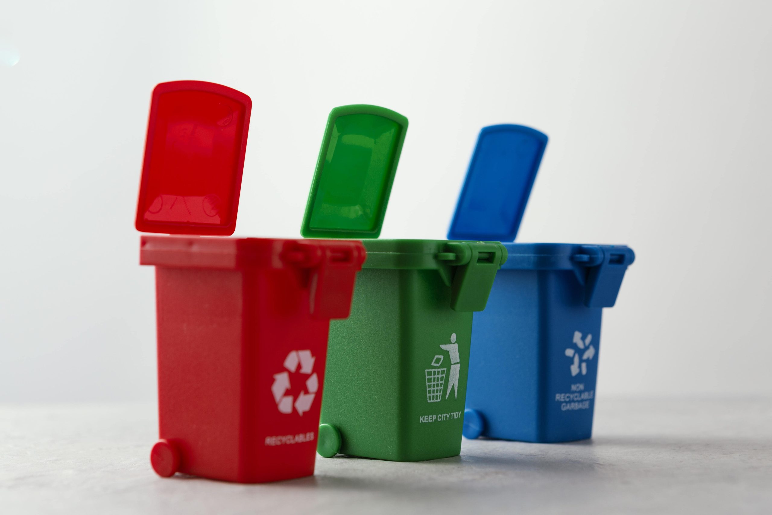 three miniature recycle bins min.